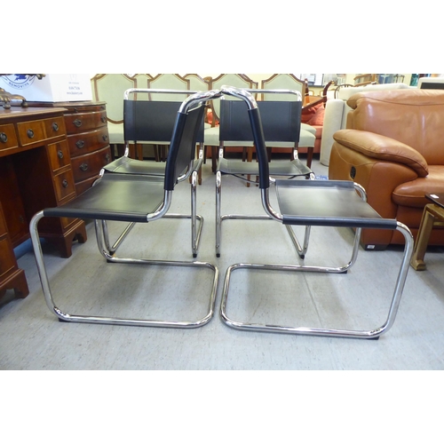 322 - A set of four chromium finished cantilever design dining chairs, each with a black leather strap bac... 