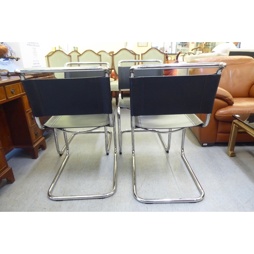 322 - A set of four chromium finished cantilever design dining chairs, each with a black leather strap bac... 