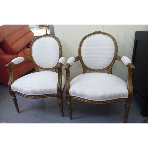 326 - A pair of modern Louis XVI design, stained beech framed salon chairs upholstered in cream coloured f... 