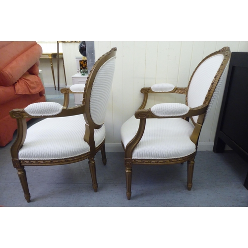 326 - A pair of modern Louis XVI design, stained beech framed salon chairs upholstered in cream coloured f... 