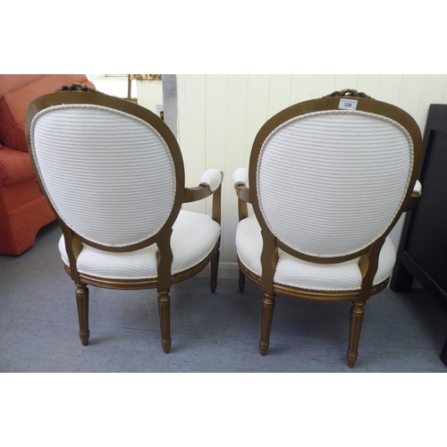 326 - A pair of modern Louis XVI design, stained beech framed salon chairs upholstered in cream coloured f... 