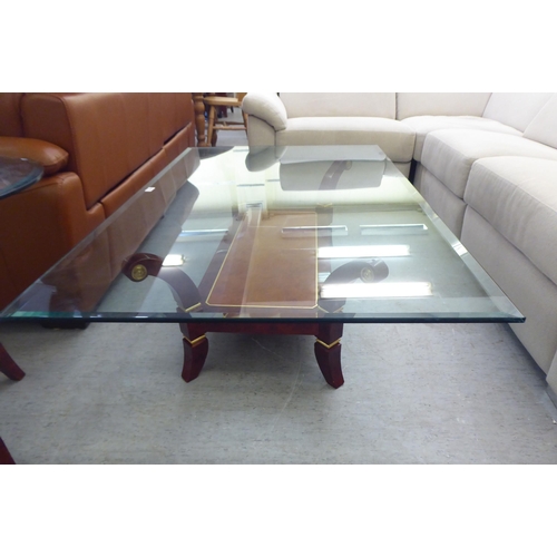 329 - A modern walnut finished coffee table with a glass top, raised on splayed legs  16