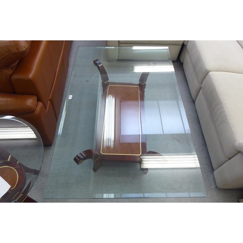 329 - A modern walnut finished coffee table with a glass top, raised on splayed legs  16