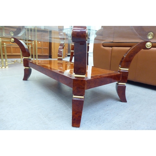 329 - A modern walnut finished coffee table with a glass top, raised on splayed legs  16