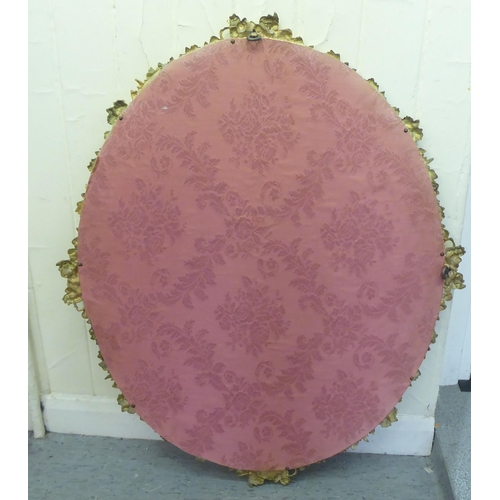 333 - A modern mirror, in a gilt metal frame, encrusted with flora  34