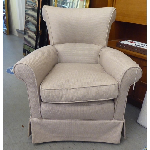 336 - A modern cream coloured fabric upholstered armchair 