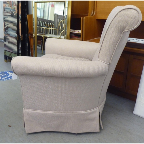 336 - A modern cream coloured fabric upholstered armchair 