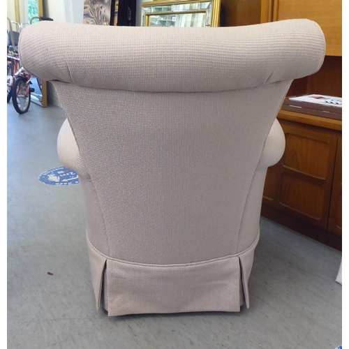 336 - A modern cream coloured fabric upholstered armchair 