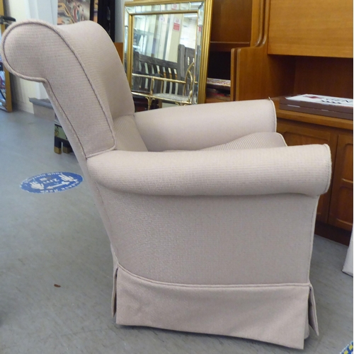 336 - A modern cream coloured fabric upholstered armchair 