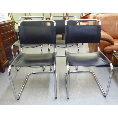 322 - A set of four chromium finished cantilever design dining chairs, each with a black leather strap bac... 