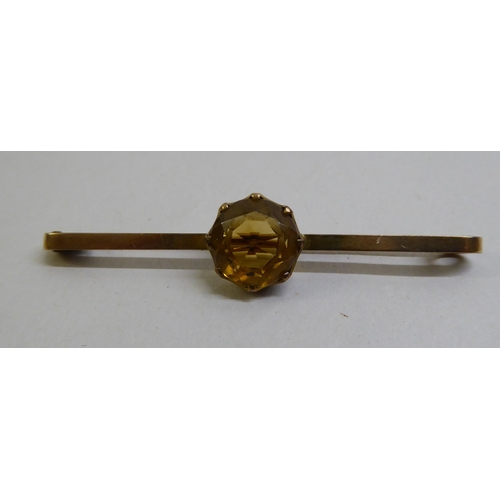 11 - Two late Victorian yellow metal bar brooches, each set with a coloured stone 