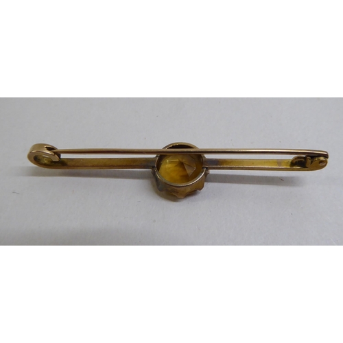 11 - Two late Victorian yellow metal bar brooches, each set with a coloured stone 