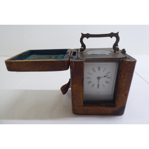 110 - A brass and bevelled glass cased carriage timepiece; the movement faced by a Roman dial  inscri... 