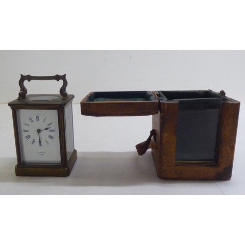 110 - A brass and bevelled glass cased carriage timepiece; the movement faced by a Roman dial  inscri... 