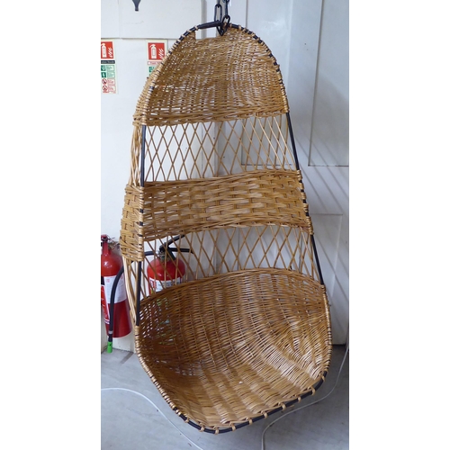 115 - A metal framed and woven cane 'Egg' hanging chair, on chain