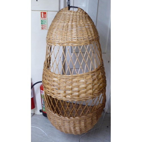 115 - A metal framed and woven cane 'Egg' hanging chair, on chain