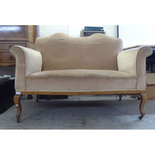 119 - An early 20thC bleached mahogany framed and mushroom coloured fabric, two person enclosed arm settee... 