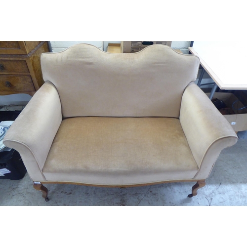 119 - An early 20thC bleached mahogany framed and mushroom coloured fabric, two person enclosed arm settee... 