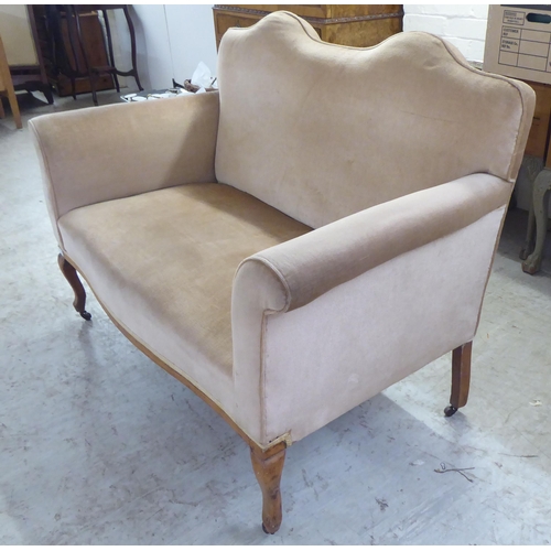 119 - An early 20thC bleached mahogany framed and mushroom coloured fabric, two person enclosed arm settee... 