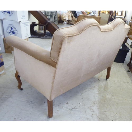 119 - An early 20thC bleached mahogany framed and mushroom coloured fabric, two person enclosed arm settee... 