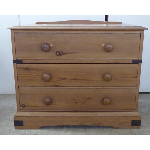 120 - A 20thC pine three drawer dressing chest, on a bracket plinth  26