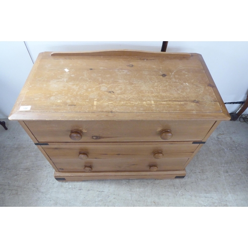 120 - A 20thC pine three drawer dressing chest, on a bracket plinth  26