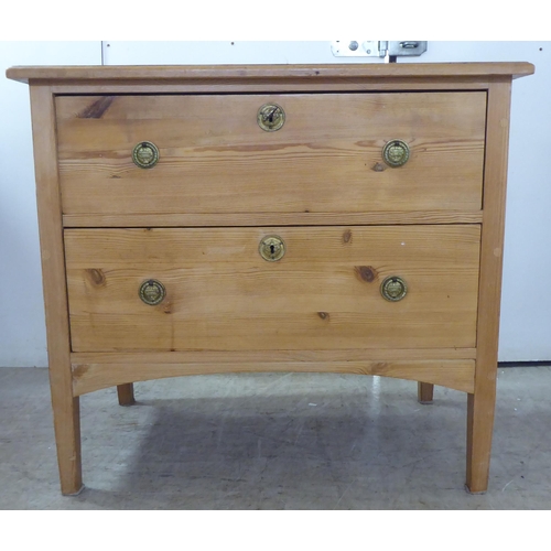 123 - A 20thC pine two drawer dressing chest, raised on square, tapered legs  30