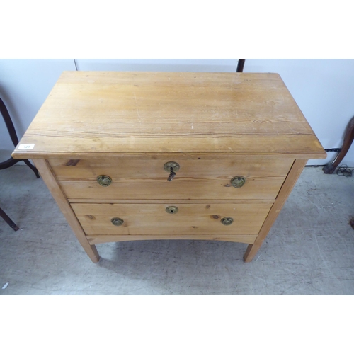 123 - A 20thC pine two drawer dressing chest, raised on square, tapered legs  30