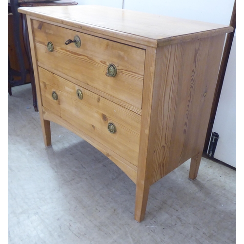 123 - A 20thC pine two drawer dressing chest, raised on square, tapered legs  30