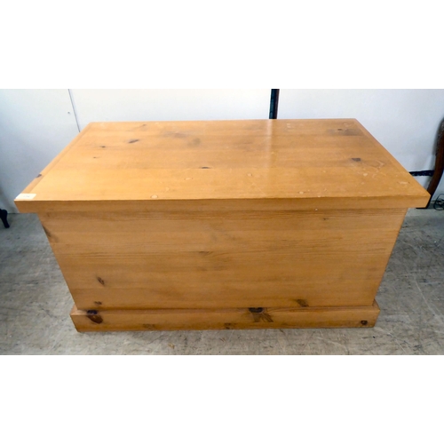 124 - A modern pine chest with straight sides and a hinged lid, on a plinth  19