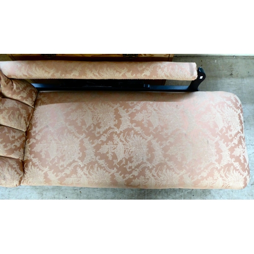 130 - An Edwardian black painted showwood framed chaise longue, upholstered in Oriental patterned fabric, ... 