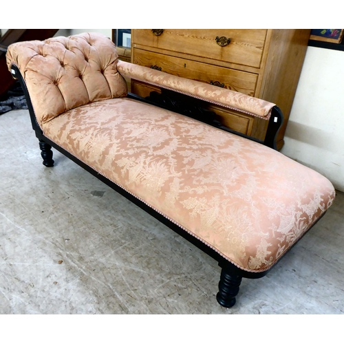 130 - An Edwardian black painted showwood framed chaise longue, upholstered in Oriental patterned fabric, ... 