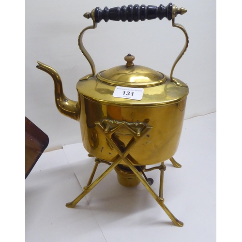 131 - A mixed lot: to include a late Victorian brass spirit kettle with an ebonised handle