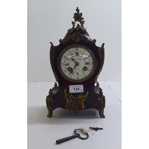 134 - A late Victorian Waring & Gillow faux tortoiseshell painted wood mantel clock with ormolu mounts... 