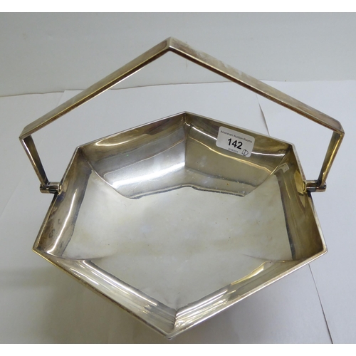 142 - A silver fruit basket of octagonal, pedestal design with a swing top handle  Sheffield 1923&nbs... 