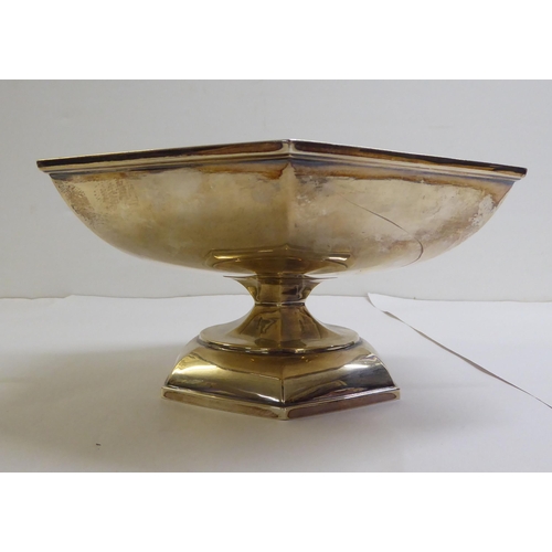 142 - A silver fruit basket of octagonal, pedestal design with a swing top handle  Sheffield 1923&nbs... 