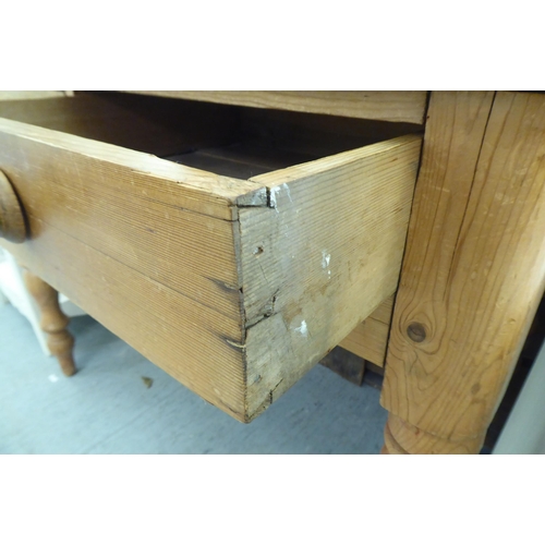 187 - A modern rustic pine side table with two frieze drawers, raised on turned legs  30.5