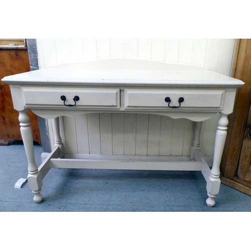 191 - A modern white painted pine side table with two frieze drawers, raised on turned legs, united by a s... 