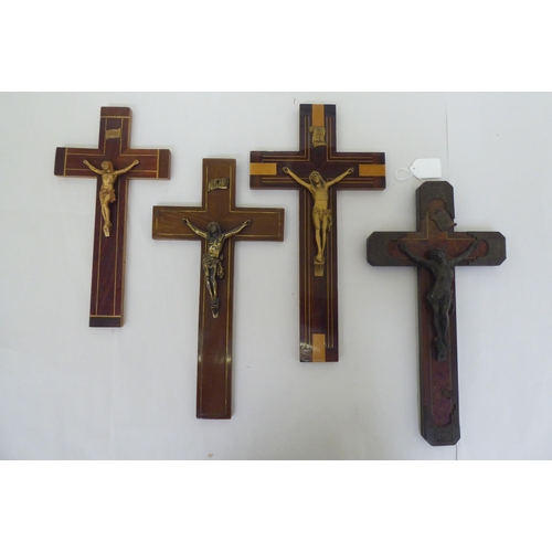 195 - Four similar crucifixes, each affixed with a cast metal Corpus Christie  largest 14