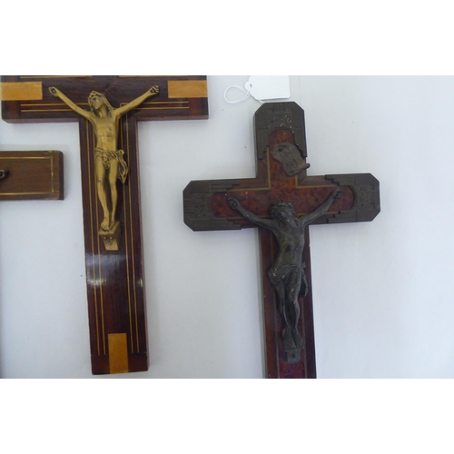 195 - Four similar crucifixes, each affixed with a cast metal Corpus Christie  largest 14