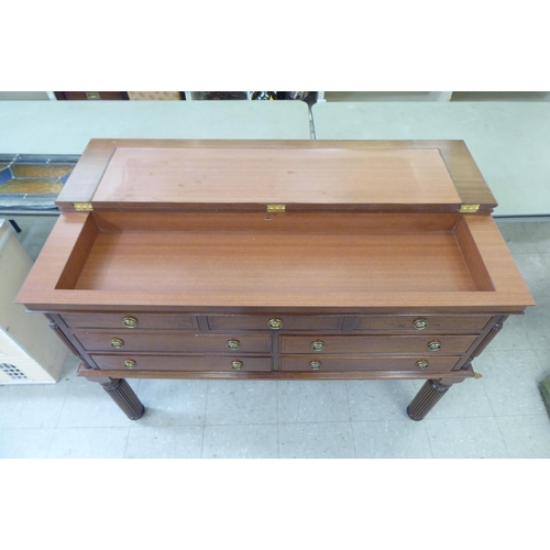 208 - A modern mahogany finished canteen cabinet containing Kings pattern cutlery and flatware, raised on ... 