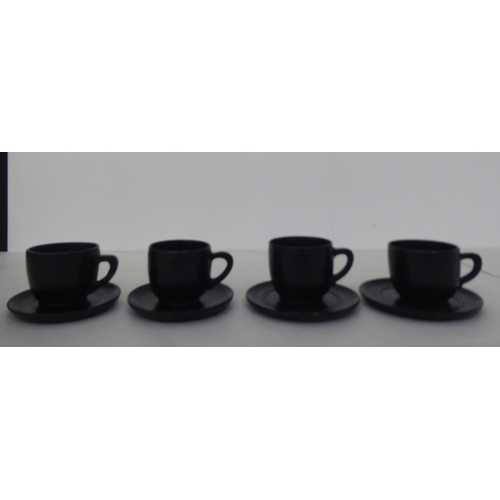 228 - Four modern bog oak cups and saucers of turned design  2.5