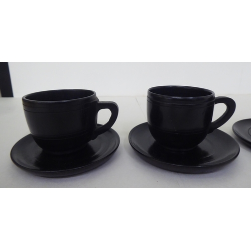 228 - Four modern bog oak cups and saucers of turned design  2.5