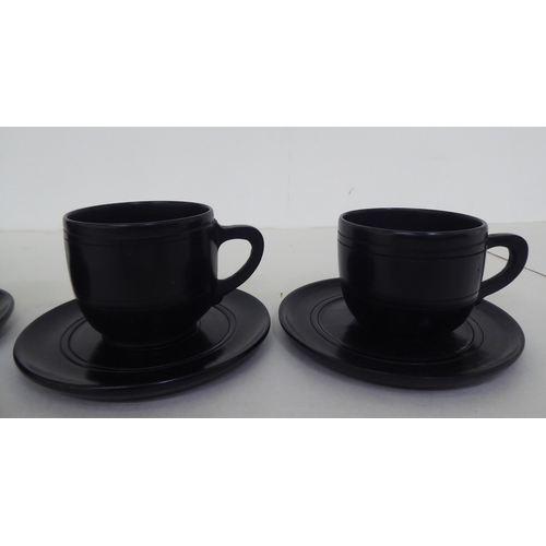 228 - Four modern bog oak cups and saucers of turned design  2.5