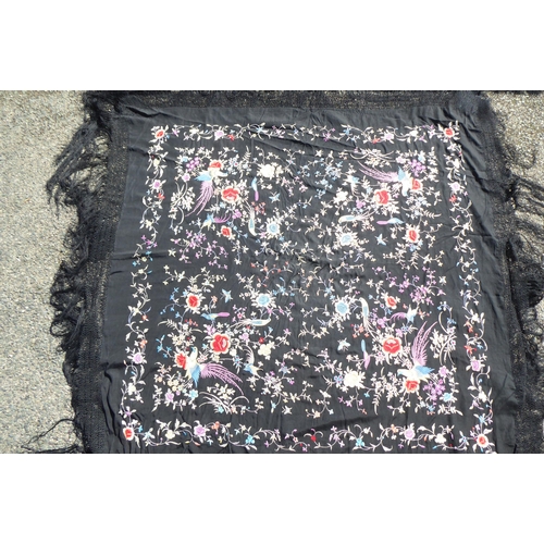 236 - An Oriental black embroidered piano shawl, decorated with flowers, birds and insects