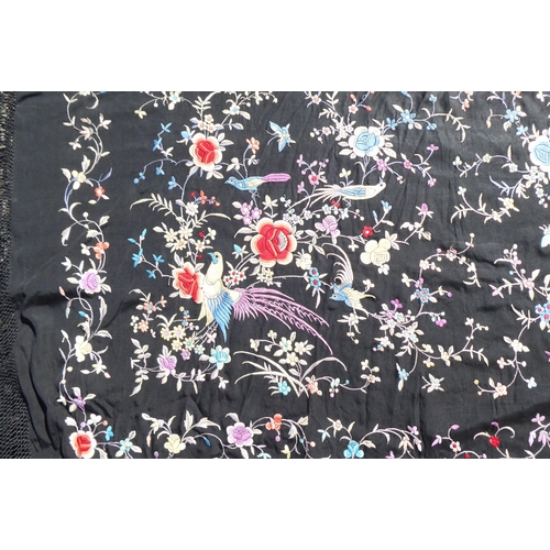 236 - An Oriental black embroidered piano shawl, decorated with flowers, birds and insects