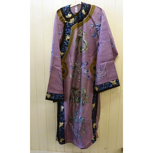 241 - A Chinese purple fabric robe dress, embroidered with flowers, birds and butterflies