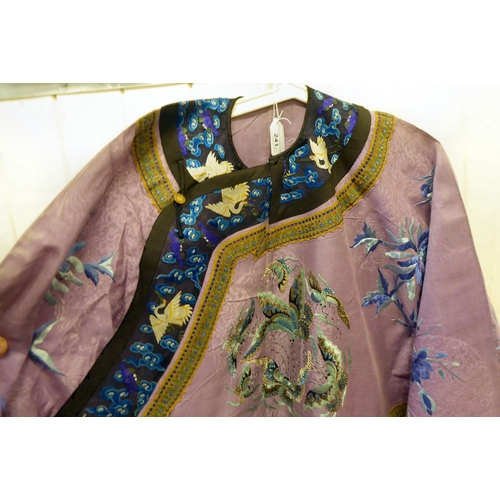 241 - A Chinese purple fabric robe dress, embroidered with flowers, birds and butterflies