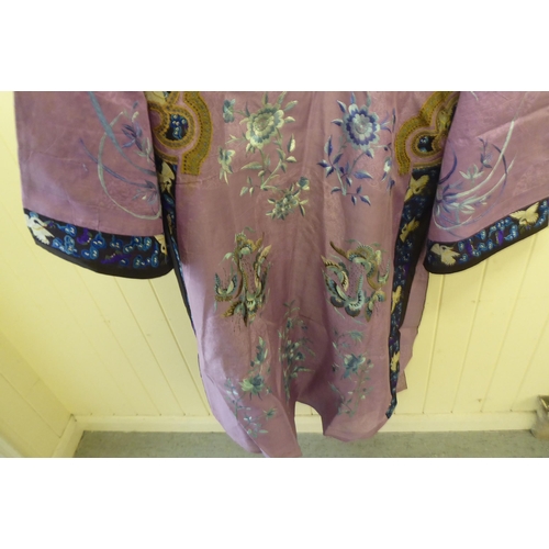 241 - A Chinese purple fabric robe dress, embroidered with flowers, birds and butterflies