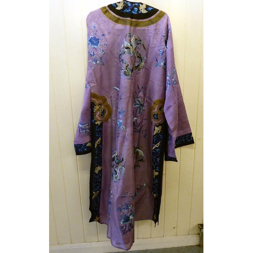 241 - A Chinese purple fabric robe dress, embroidered with flowers, birds and butterflies